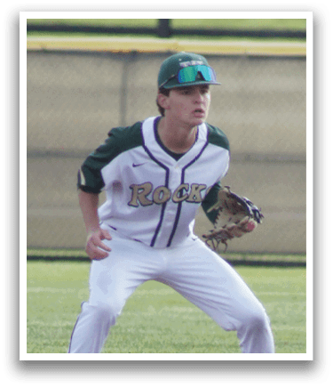 A baseball player in a white uniform is playing in a baseball game. Description generated by AI