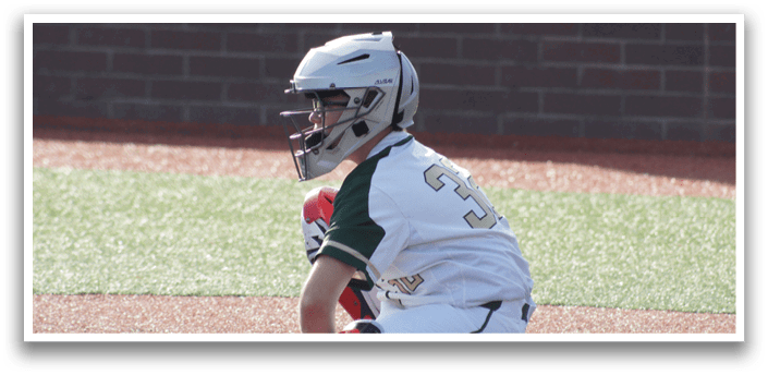 A baseball player wearing a helmet and sitting on the ground. Description generated by AI