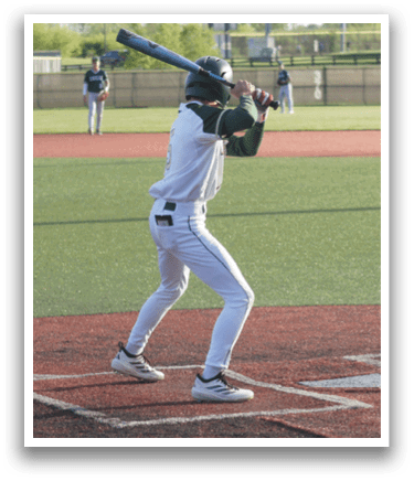 A baseball player is swinging a bat on a field. Description generated by AI