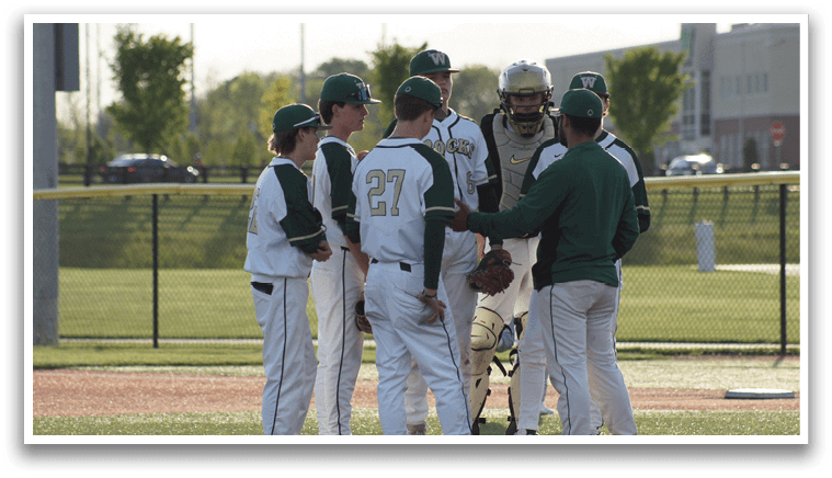A group of baseball players standing on a field. Description generated by AI