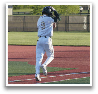 A baseball player wearing a white uniform and a green helmet. Description generated by AI