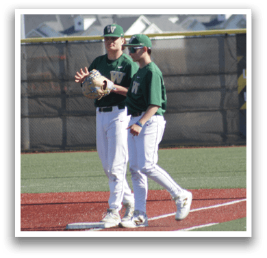 A group of baseball players wearing green and white uniforms. Description generated by AI