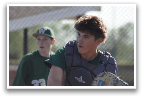 Two baseball players standing on a field. Description generated by AI