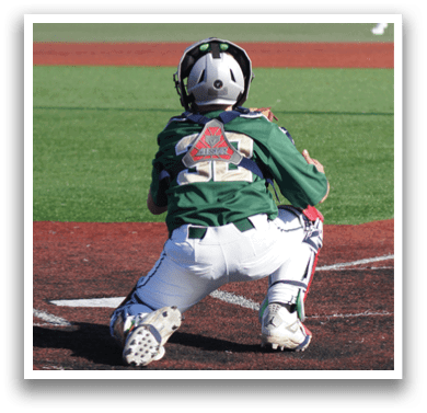 A baseball player wearing a white uniform and a green helmet. Description generated by AI
