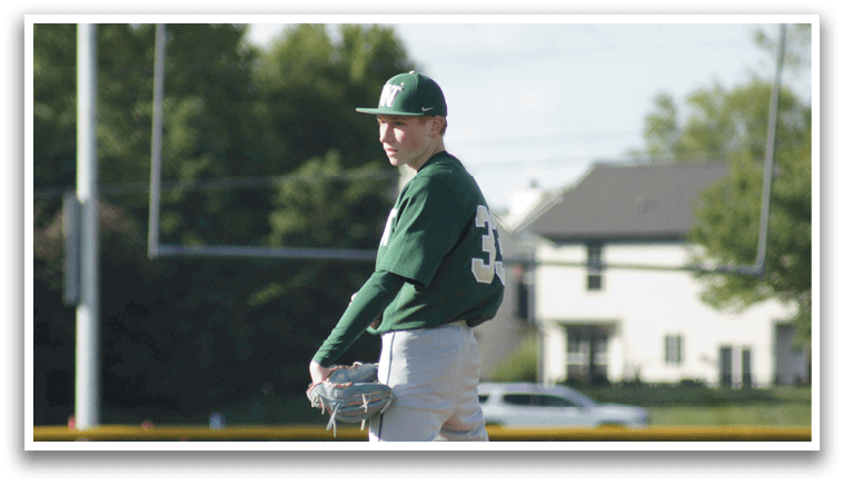 A group of baseball players wearing green and white uniforms. Description generated by AI
