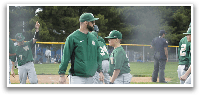A baseball player wearing a green and white uniform is running towards a base. Description generated by AI