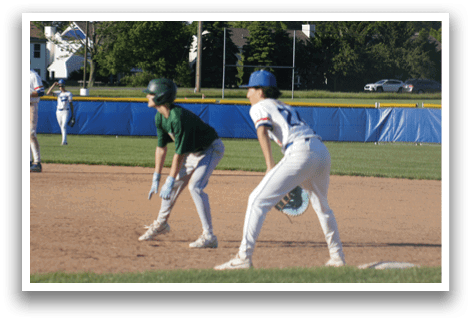 A baseball player is standing at home plate, holding a bat. Description generated by AI