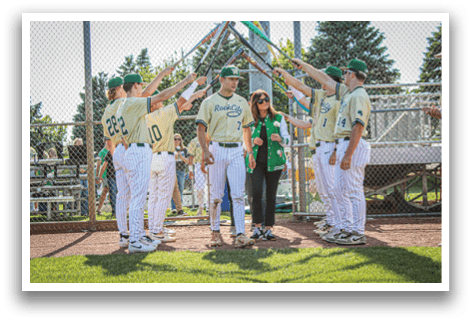 A group of baseball players standing on a field. Description generated by AI