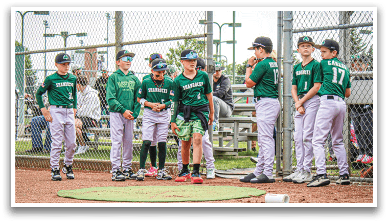 Baseball players sitting on a bench. Description generated by AI