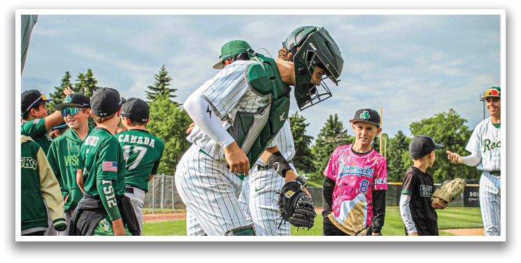 A baseball player wearing a white uniform and a green hat. Description generated by AI