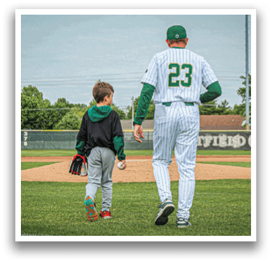 A baseball player wearing a white uniform and a green hat. Description generated by AI