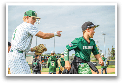 A baseball player wearing a green and white uniform with the number 6 on the back. Description generated by AI