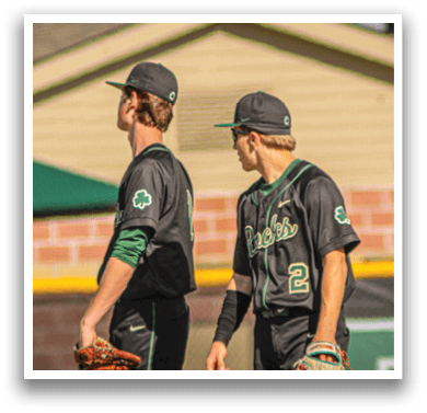 A baseball player wearing a green helmet and white uniform. Description generated by AI