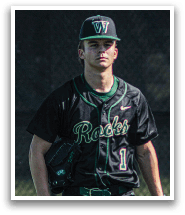 A baseball player is holding a bat and getting ready to hit the ball. Description generated by AI
