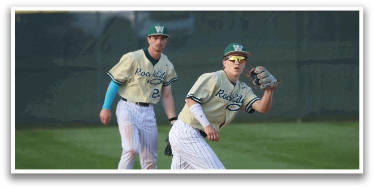 A man wearing a baseball uniform is laughing. Description generated by AI
