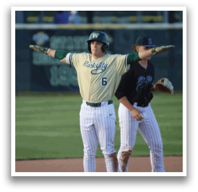 A baseball player wearing a green helmet and white uniform. Description generated by AI