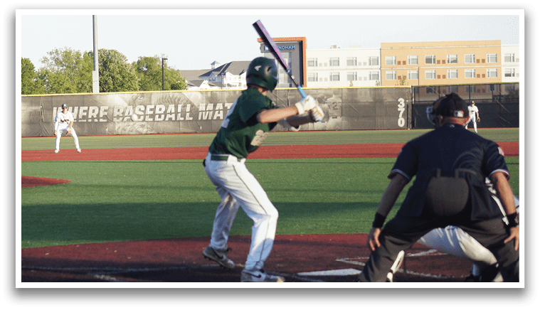 A group of baseball players standing on a field. Description generated by AI