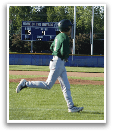 A baseball player in a green shirt and white pants is throwing a ball. Description generated by AI