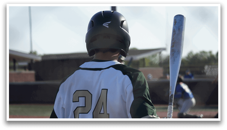 A group of baseball players wearing green and white uniforms. Description generated by AI