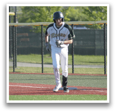 A baseball player in a green and white uniform is standing on the field. Description generated by AI
