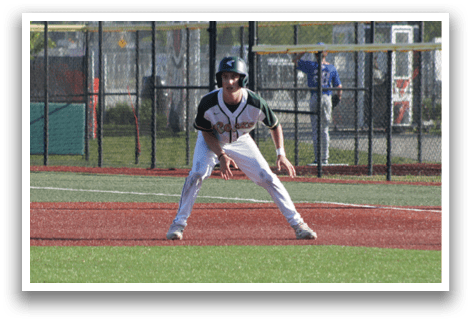 A baseball player in a green shirt and white pants is pitching a ball. Description generated by AI