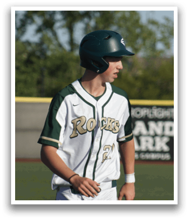 A baseball player in a green shirt and white pants is throwing a ball. Description generated by AI