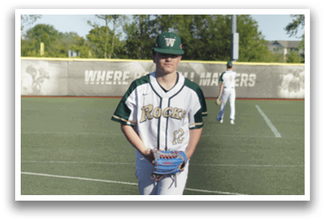 A baseball player is standing at home plate, holding a bat. Description generated by AI