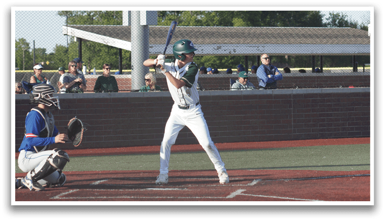 A boy wearing a green shirt and red pants is playing baseball. Description generated by AI