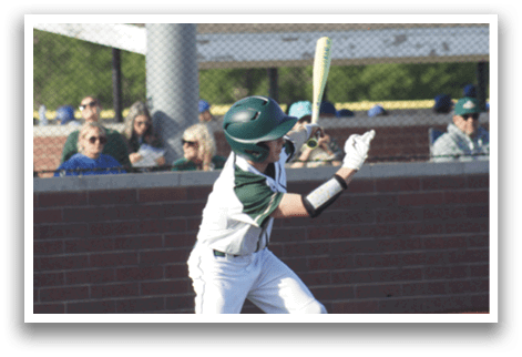 A baseball player is standing at home plate, holding a bat. Description generated by AI