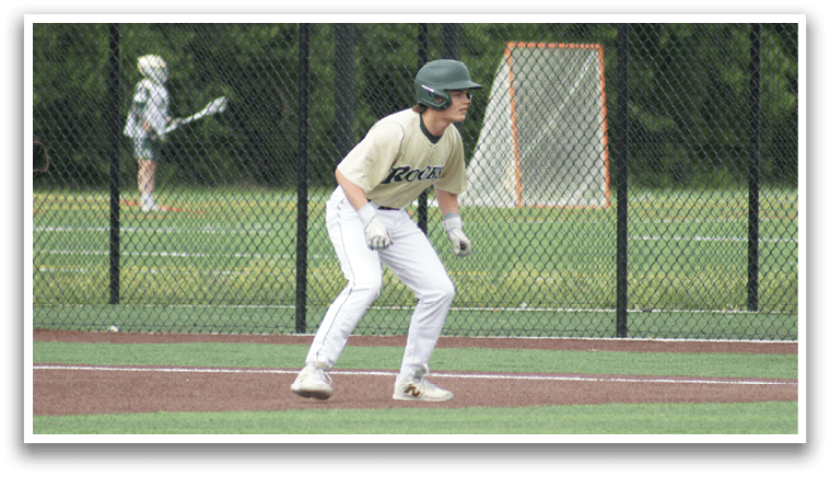 A group of baseball players wearing green and white uniforms. Description generated by AI