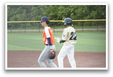 A baseball player is standing at home plate, holding a bat. Description generated by AI