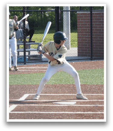 A baseball player in a green shirt and white pants is throwing a ball. Description generated by AI