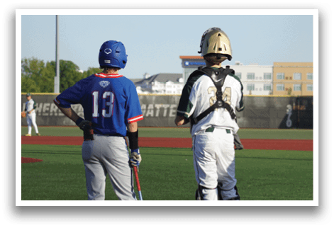 A baseball player is standing at home plate, holding a bat. Description generated by AI