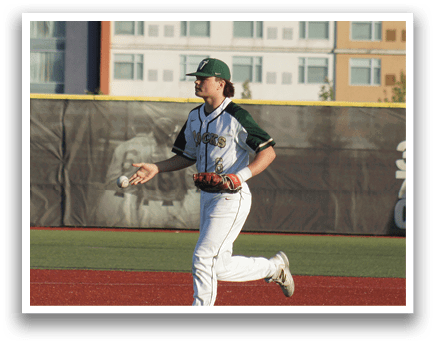 A baseball player in a green and white uniform is holding a bat and getting ready to swing. Description generated by AI