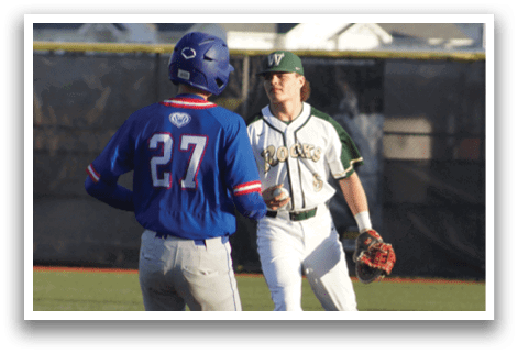 A baseball player is standing at home plate, holding a bat. Description generated by AI