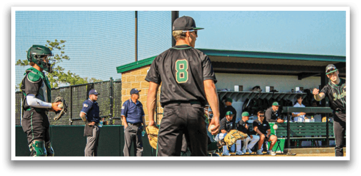 Three baseball players wearing white and green uniforms. Description generated by AI