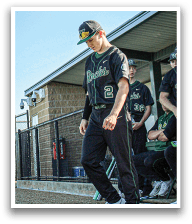 A baseball player is holding a bat and getting ready to hit the ball. Description generated by AI
