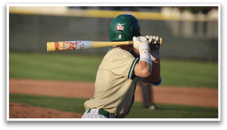 A baseball player is swinging a bat on a field. Description generated by AI