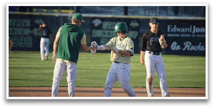 A man wearing a baseball uniform is laughing. Description generated by AI