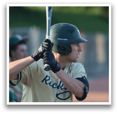 A baseball player wearing a green helmet and white uniform. Description generated by AI