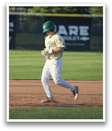 A baseball player is holding a bat and getting ready to hit the ball. Description generated by AI