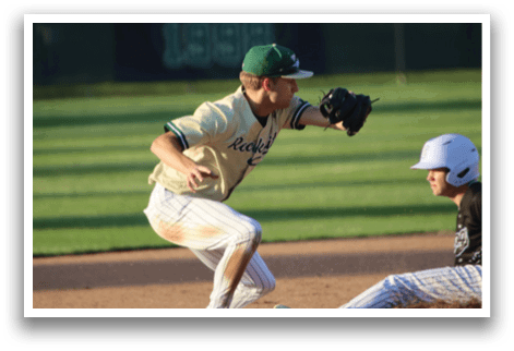 A baseball player wearing a green helmet and green pads. Description generated by AI