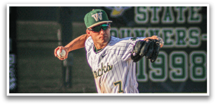 A baseball player wearing a white uniform and green hat catching a ball. Description generated by AI