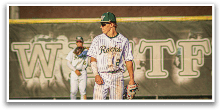 A baseball player wearing a white uniform and a green hat. Description generated by AI