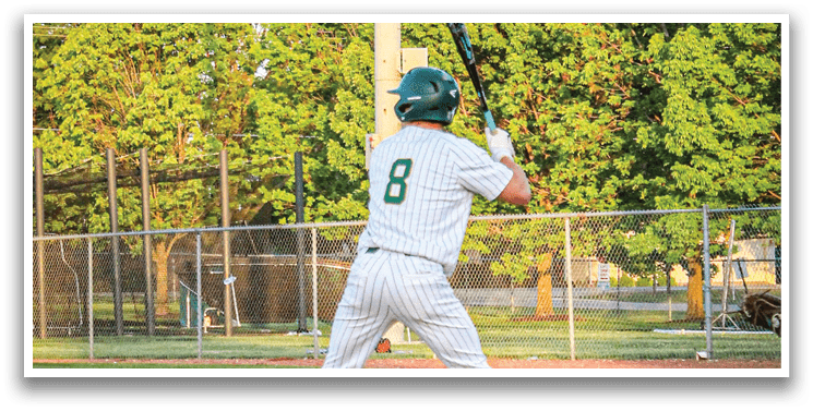 A baseball player holding a bat on a field. Description generated by AI