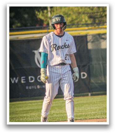 A baseball player wearing a green and white uniform. Description generated by AI