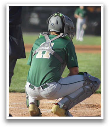 A baseball catcher wearing a green and white uniform. Description generated by AI