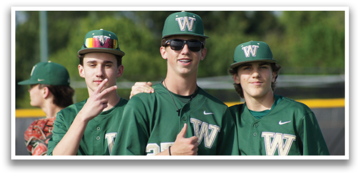 Three baseball players wearing green shirts and sunglasses. Description generated by AI