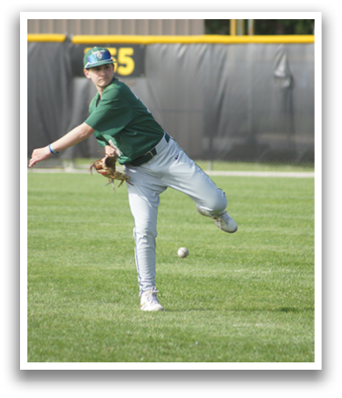 A man in a green shirt and white pants is kicking a ball. Description generated by AI
