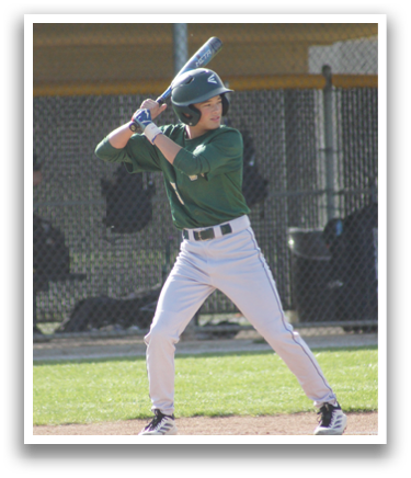 A baseball player in a green shirt and white pants is swinging a bat. Description generated by AI